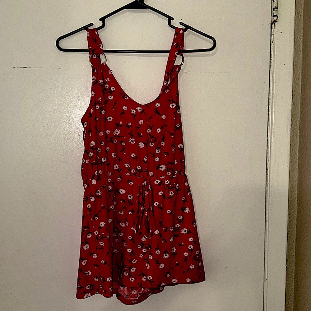 This is a bright red flower print extra small comfortable romper never worn